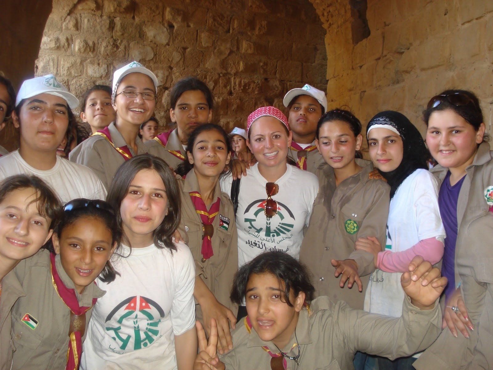 Allison standing with a group of children during her time in the Peace Corps in Jordan