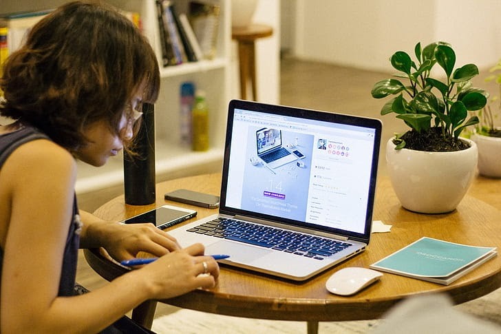 A woman working on her laptop at home